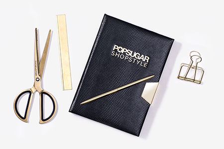 Custom made black notebook with gold foiled logo and metal closing clip