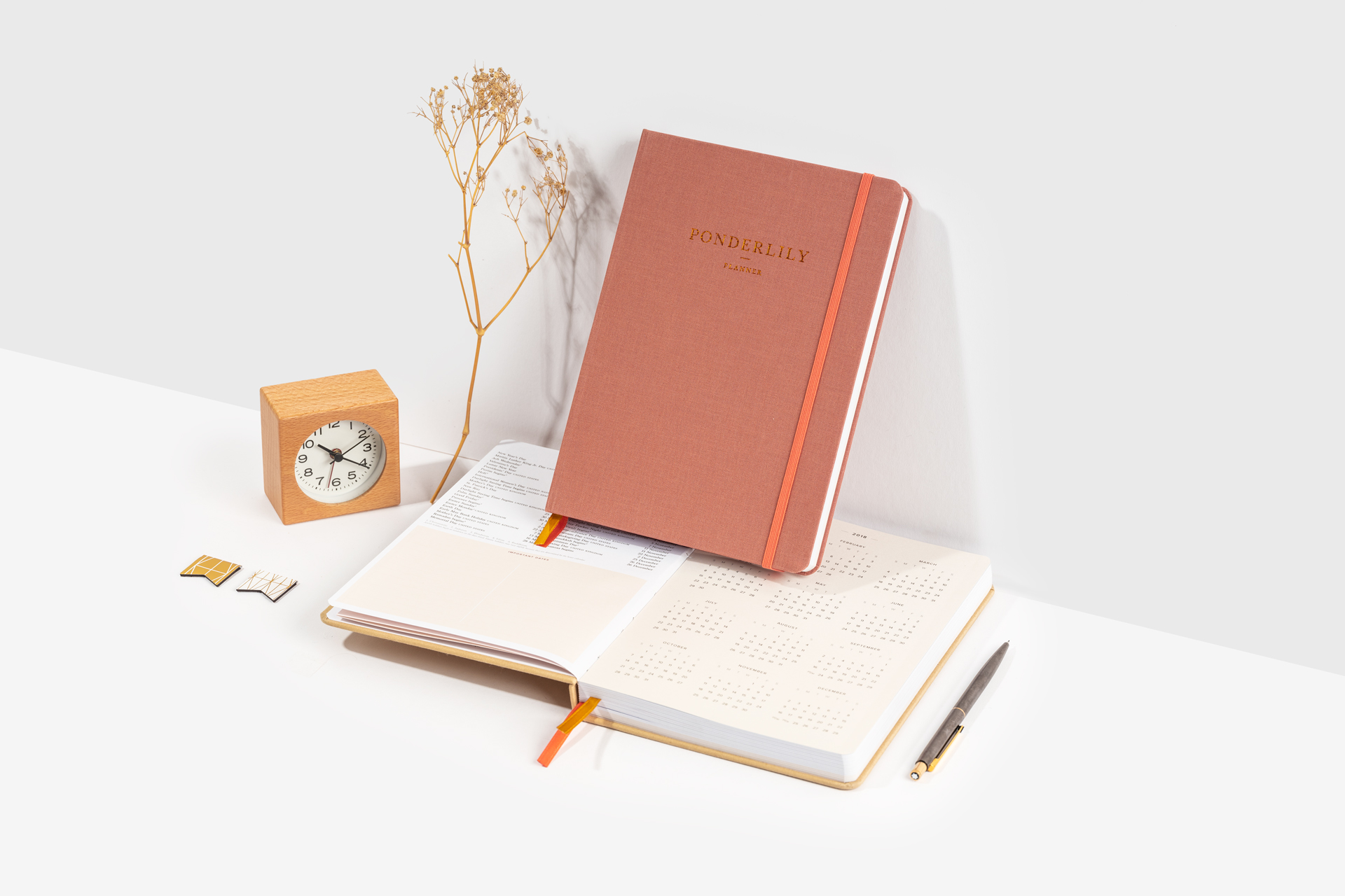 Closed and open Ponderlilly hardcover clothbound planners with copper foiling on the cover