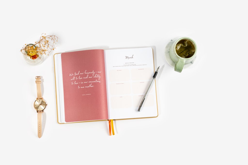 Open clothbound planner with printed pages