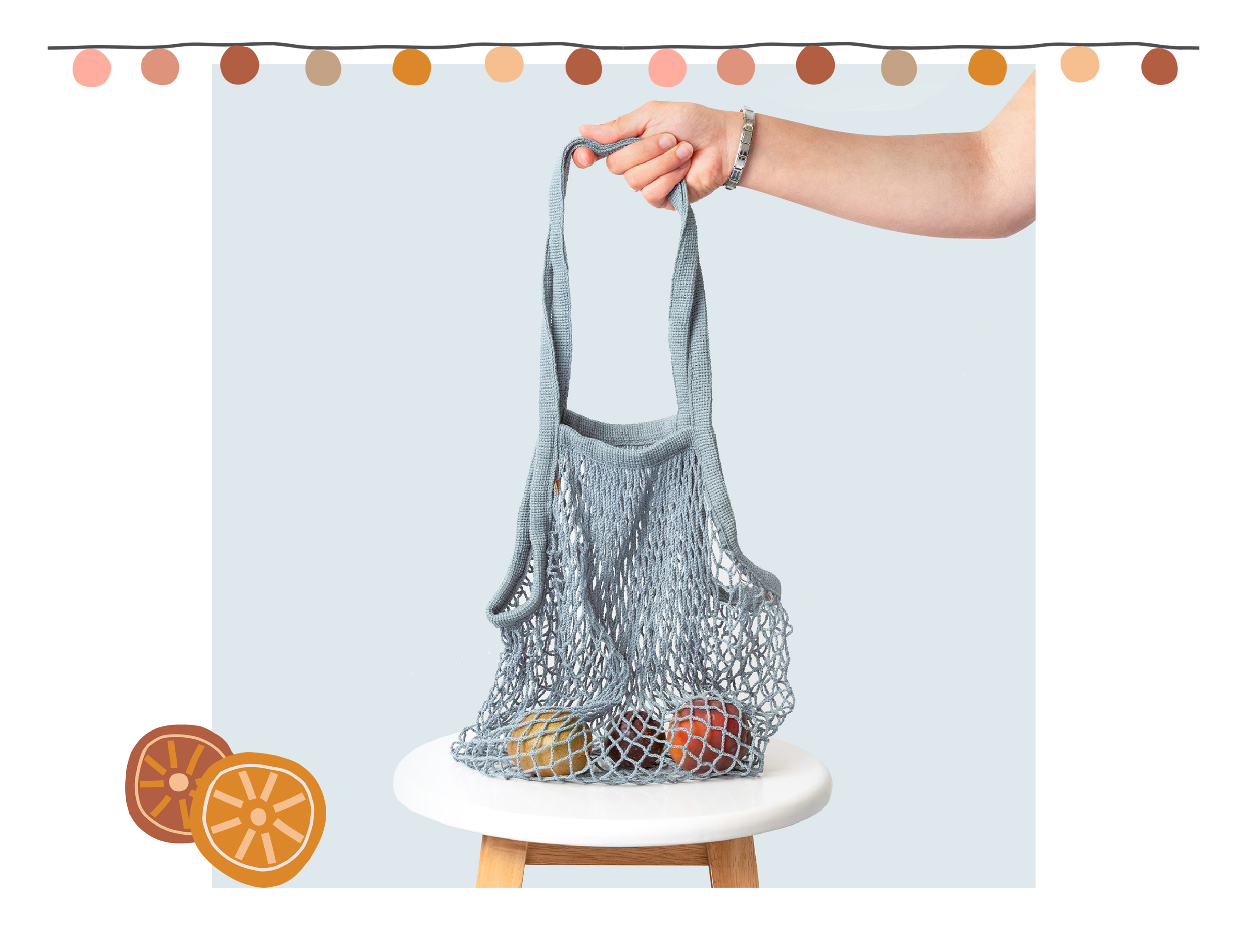 Duck Egg Blue Mesh Cotton Bag with decorative lemons and Christmas lights in oranges, pinks and browns